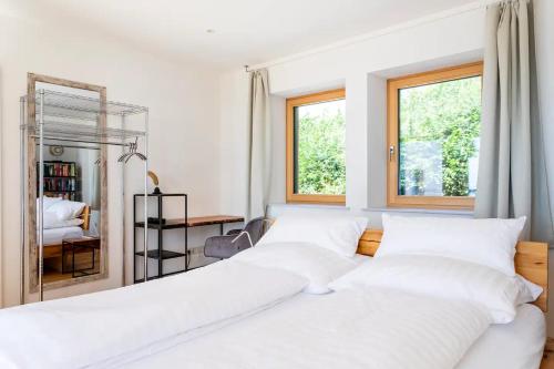 a bedroom with two beds and a desk and two windows at Schilcher-Residenz in Steinreib