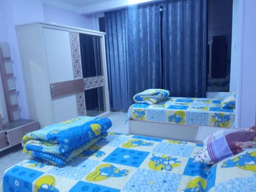 1 dormitorio con 2 camas y ventana en Sun, Sea & Comfort en Hurghada