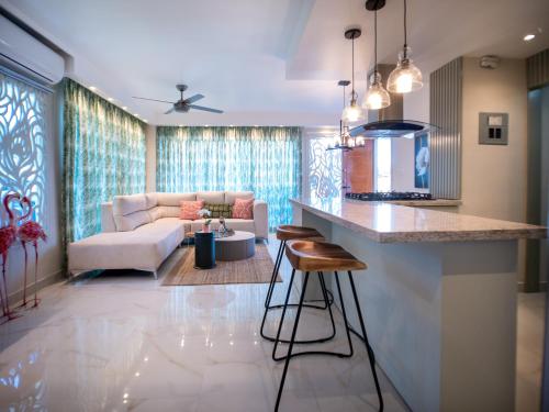 a kitchen and living room with a bar and a couch at Coconut Paradise Beach Hotel in Pajarito