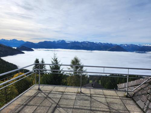 a balcony with a view of a lake and mountains at Hotel Bergsonne Rigi in Rigi Kaltbad