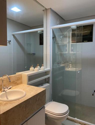 a bathroom with a shower and a toilet and a sink at Apartamento Alto da Serra Villas in Bananeiras