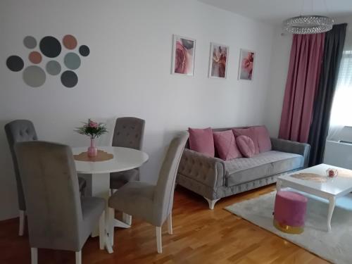 a living room with a couch and a table at Skyline apartment in Bijeljina