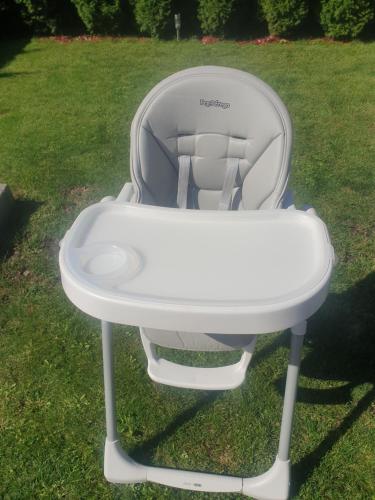 a white high chair sitting in the grass at Wellness Villa Diana in Boldogkőváralja