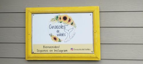 a picture of a sign on the side of a building at Girasoles de Valdes in Puerto Pirámides