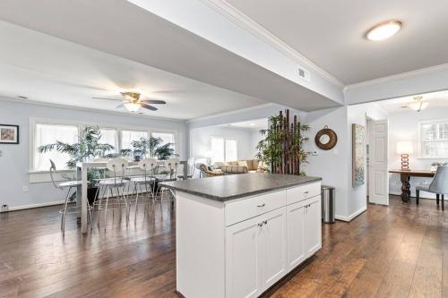 a kitchen and dining room with white cabinets and a table at The Bamboo House! Dog-Friendly Home n RVA Sleeps 8 in Richmond