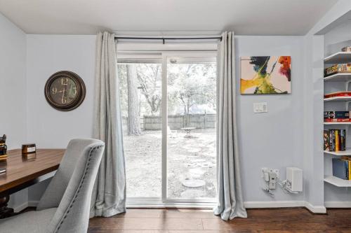 a dining room with a table and a sliding glass door at The Bamboo House! Dog-Friendly Home n RVA Sleeps 8 in Richmond