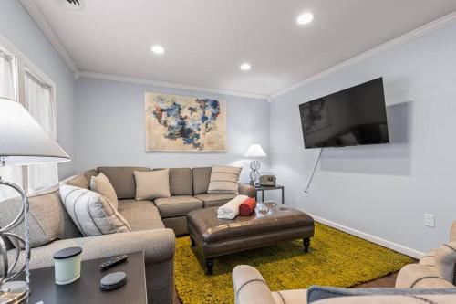 a living room with a couch and a flat screen tv at The Bamboo House! Dog-Friendly Home n RVA Sleeps 8 in Richmond
