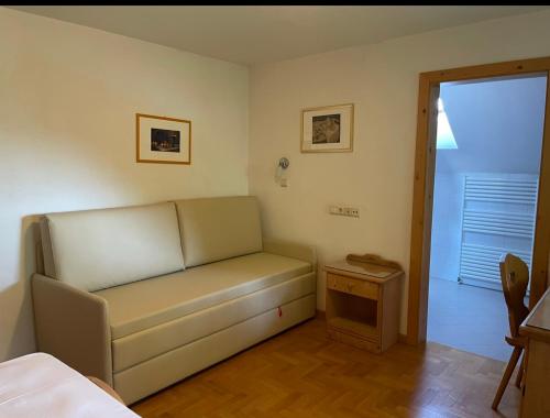 a bed room with a couch and a window at Naturhotel Wieserhof in Longostagno