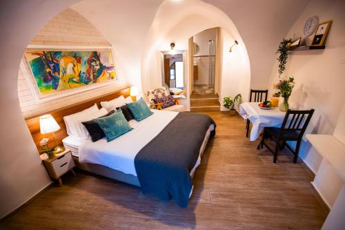 a bedroom with a bed and a table in a room at Maim Haim Tzfat - Boutique Suites Prime location Old City Tzfat in Safed