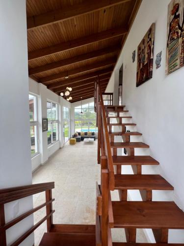 a staircase in a house with wooden ceilings at Coconut Paradise Beach Hotel in Pajarito