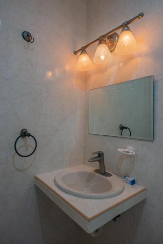 a bathroom with a sink and a mirror at Marysol beachfront next to nomads d7 in Isla Mujeres