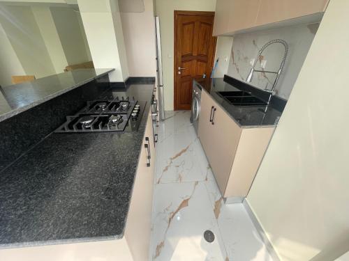 a kitchen with black and white marble counter tops at Pimenova Residence in Luanda