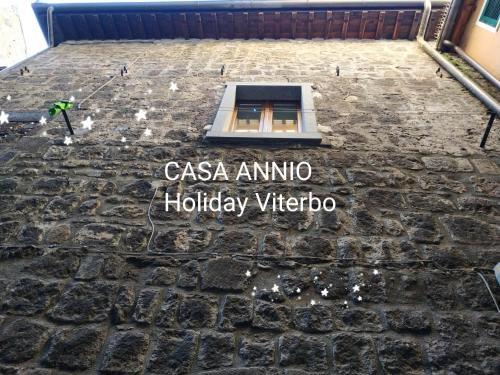 a sign on the side of a building with a window at CASA ANNIO Holiday Viterbo in Viterbo