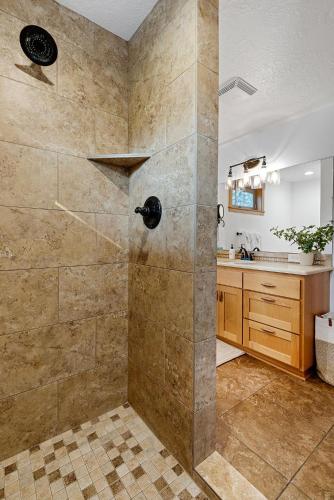 a bathroom with a shower and a sink at Sisters Basecamp - Meredith Lodging in Sisters