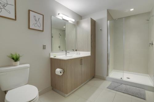 a bathroom with a toilet and a sink and a shower at Fantastic Condo 1BR at Crystal Flats in Arlington