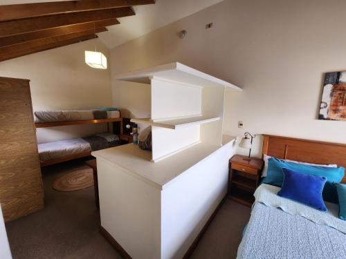 a living room with a white counter and a couch at Ushuhouse Apartments in Ushuaia