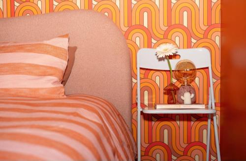 a bedroom with a bed and a side table with a clock at The Greeen Room in Launceston