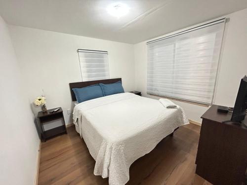 a bedroom with a large bed and a window at Cabaña Freirina in Freirina