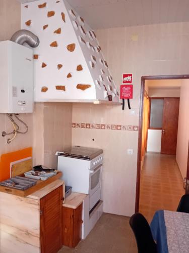 a kitchen with a stove top oven next to a counter at T3 2 Andar Ref 007 in Tavira