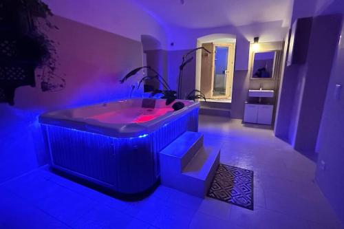 a bathroom with a tub with blue lights in it at African Paradise with Jacuzzi & Sauna in Vienna