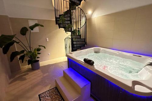 a large bath tub with blue lights in a bathroom at African Paradise with Jacuzzi & Sauna in Vienna