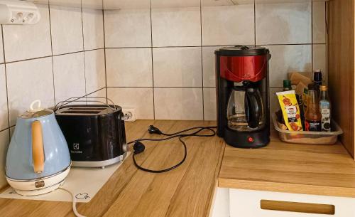 a kitchen counter with a coffee maker and a blender at Capsule Hotel Ibedcity in Rovaniemi