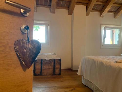 a room with a heart hanging on the wall at b&b Agriturismo San Matteo in Chiavicone