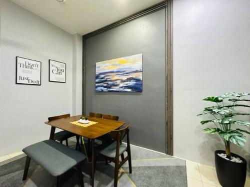 a dining room with a table and a potted plant at FATEHA HOMESTAY PENDANG in Pendang