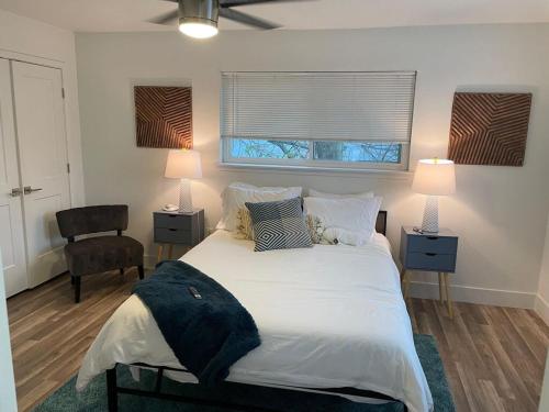 - une chambre dotée d'un grand lit avec des draps et des oreillers blancs dans l'établissement Casa Wooten - Pet Friendly, à Austin
