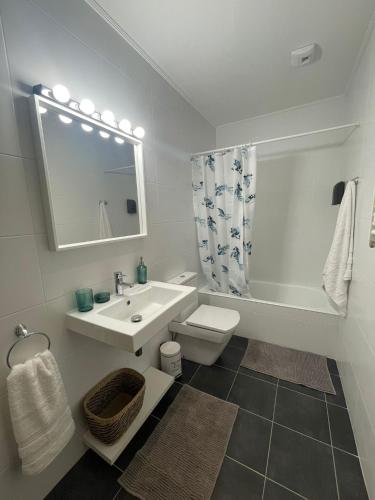 a bathroom with a sink and a toilet and a mirror at MODERN BILBAO in Barakaldo