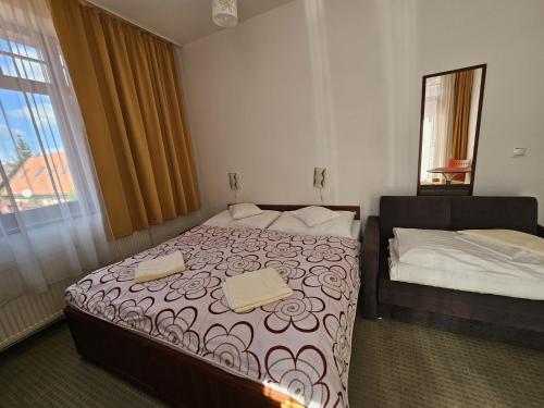 a hotel room with a bed and a window at Penzion pod Krivanom in Liptovský Hrádok