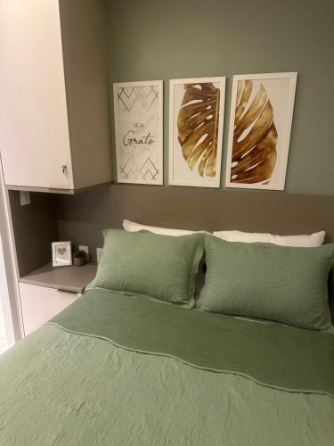 a bedroom with a bed with four pictures on the wall at Flat praia dos carneiros eco resort 26 in Tamandaré