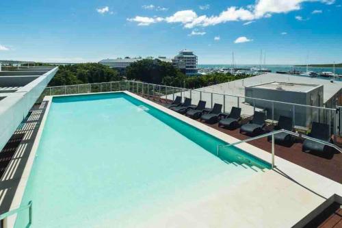 a swimming pool on the roof of a building at Oasis at Harbour lights Cairns in Cairns