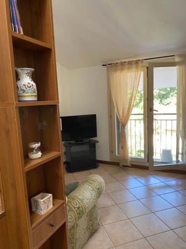 a living room with a couch and a tv at via Cappuccini 2b - soggiorna in centro a Gorizia con ascensore in Gorizia