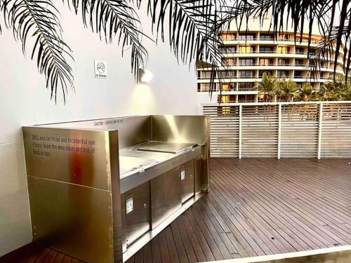 a counter in a room with a building in the background at Oasis at Harbour lights Cairns in Cairns