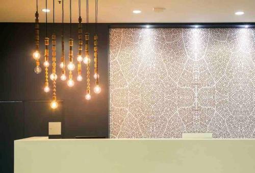 a lobby with chandeliers hanging over a counter at Oasis at Harbour lights Cairns in Cairns