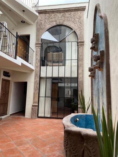 a large building with a fountain in a courtyard at Casa Laberinto in San Miguel de Allende