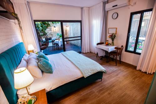 a bedroom with a bed and a table and a dining room at Villa Maim Haim Prime Location Old City Tzfat in Safed