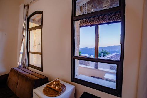 a bathroom with two large windows and a toilet at Villa Maim Haim Prime Location Old City Tzfat in Safed