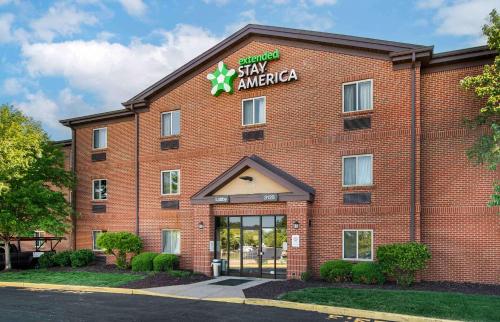 a large red brick building with a sign on it at Extended Stay America Select Suites - St Louis - Earth City in Earth City