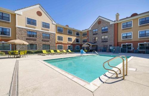 a swimming pool at a apartment complex at Extended Stay America Suites - San Diego - Carlsbad Village by the Sea in Carlsbad