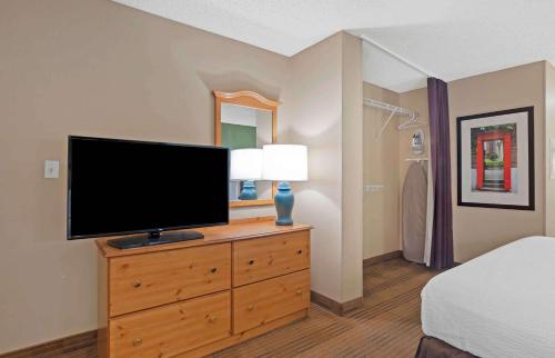 a bedroom with a flat screen tv on a dresser at Extended Stay America Suites - San Diego - Sorrento Mesa in Sorrento