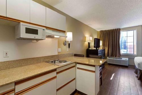 a kitchen with a counter top and a living room at Extended Stay America Suites - San Jose - Downtown in San Jose