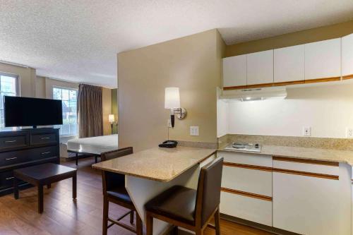 a kitchen and living room with a table and chairs at Extended Stay America Suites - San Jose - Downtown in San Jose