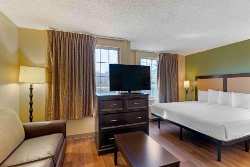 a hotel room with a bed and a flat screen tv at Extended Stay America Suites - San Jose - Downtown in San Jose