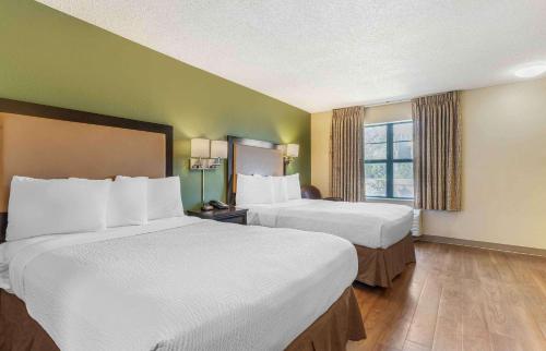 a hotel room with two beds and a window at Extended Stay America Suites - Richmond - Hilltop Mall in Richmond