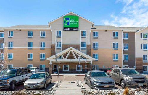 a large building with cars parked in a parking lot at Extended Stay America Select Suites - Colorado Springs in Colorado Springs