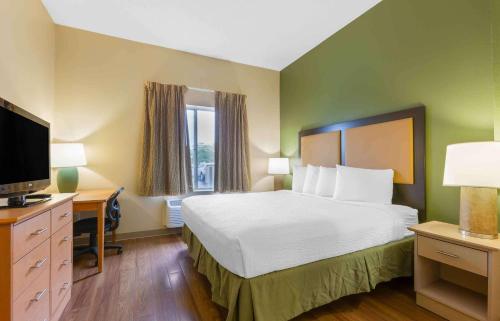 a hotel room with a bed and a television at Extended Stay America Suites - Findlay - Tiffin Avenue in Findlay