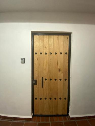 a pair of wooden doors in a room at Casa Laberinto in San Miguel de Allende