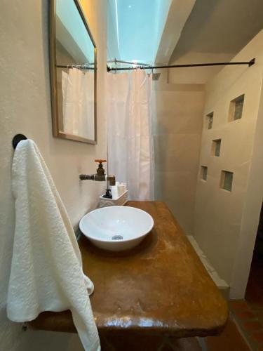 a bathroom with a white sink and a mirror at Casa Laberinto in San Miguel de Allende